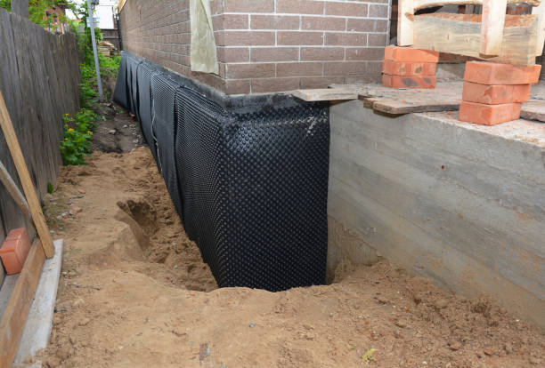 SJ Waterproofing Pros technician performing targeted Interior Drainage System assessment in Newton, KS